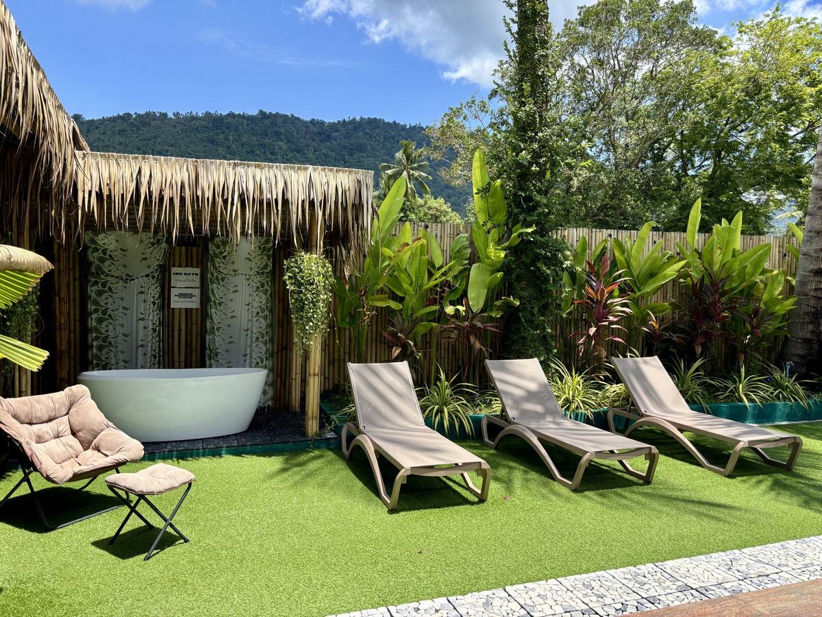 The garden at Vihara looking out to the Lamai hills, loungers, ice bath and bamboo walls