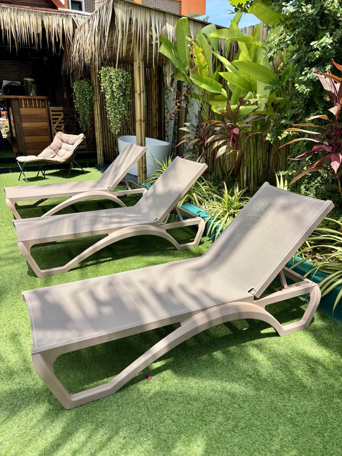 Loungers on the lawn in the garden at Vihara