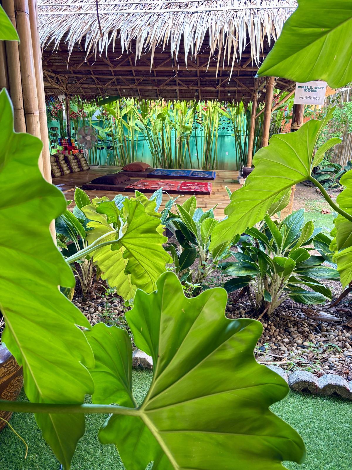 Massage beds in the open-air sala at Vihara, seen through tropical planting